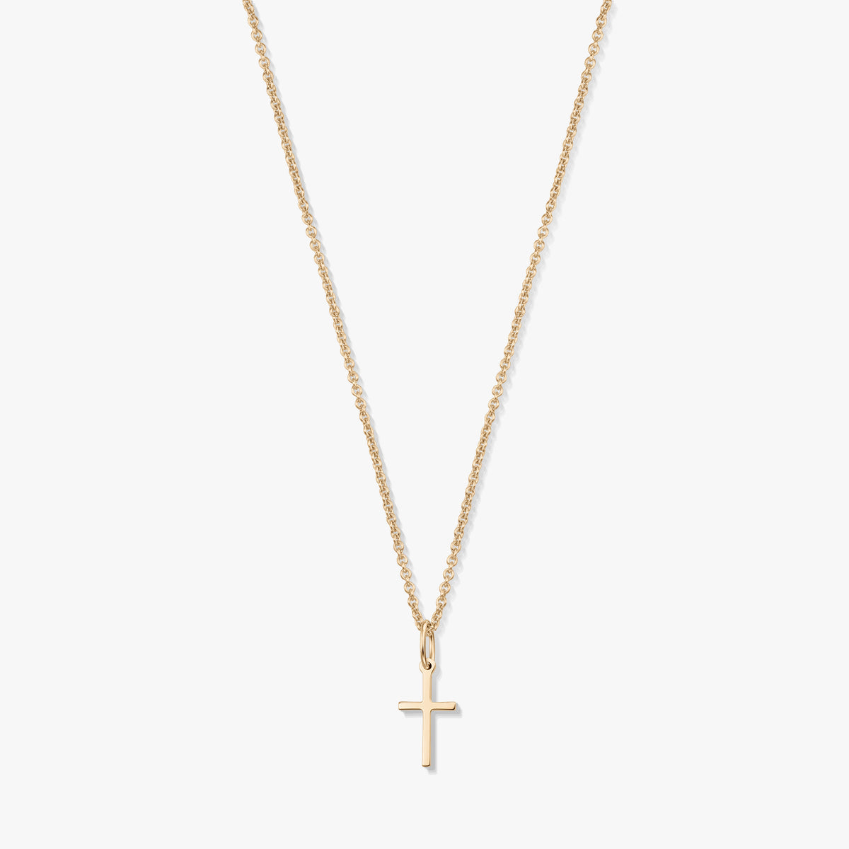Minimalista 14K sárga arany nyaklánc apró kereszt medállal, finom láncon, fehér háttéren.