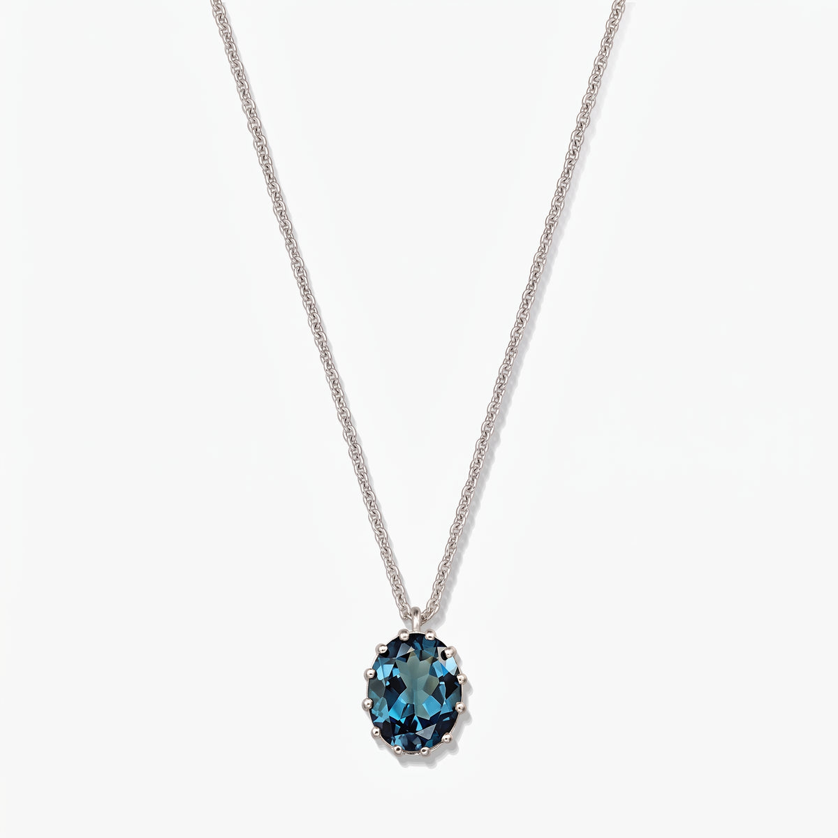 Sterling ezüst nyaklánc ovális London blue topaz medállal, fehér háttéren.
